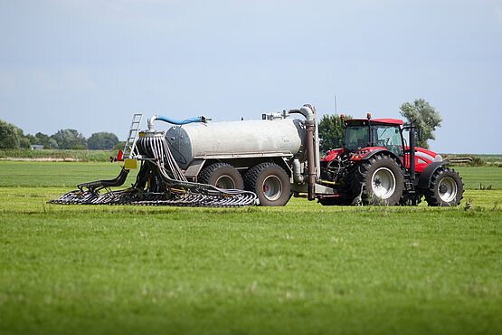 Tractor distributes organic fertilizer on a field